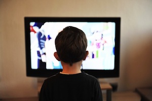 Are you sitting comfortably? Photo of boy watching TV