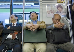 Sleeping on the job. Photo of commuters asleep
